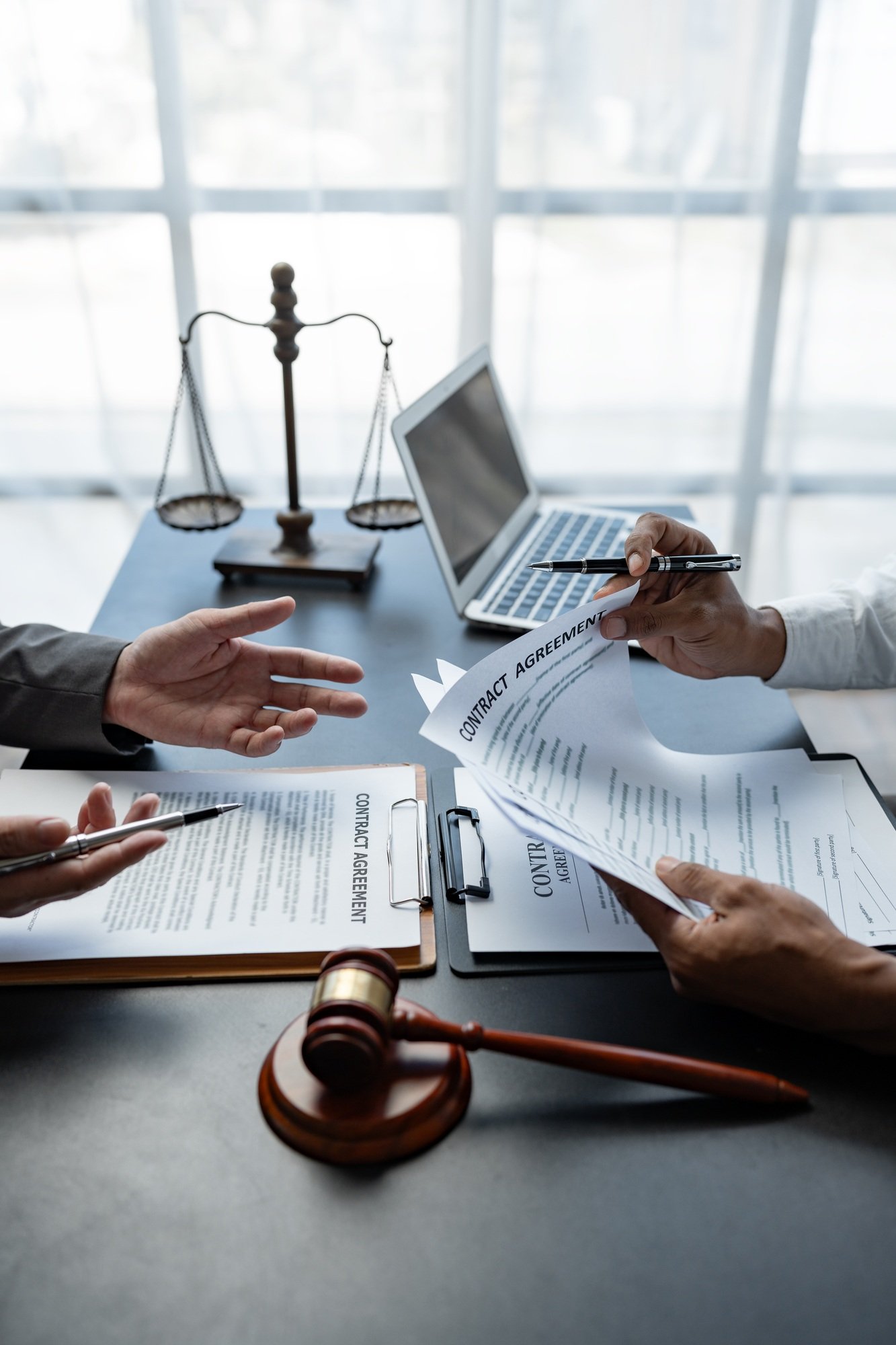 Attorneys or lawyer reading statute of limitations, consulting between male lawyers and business cli